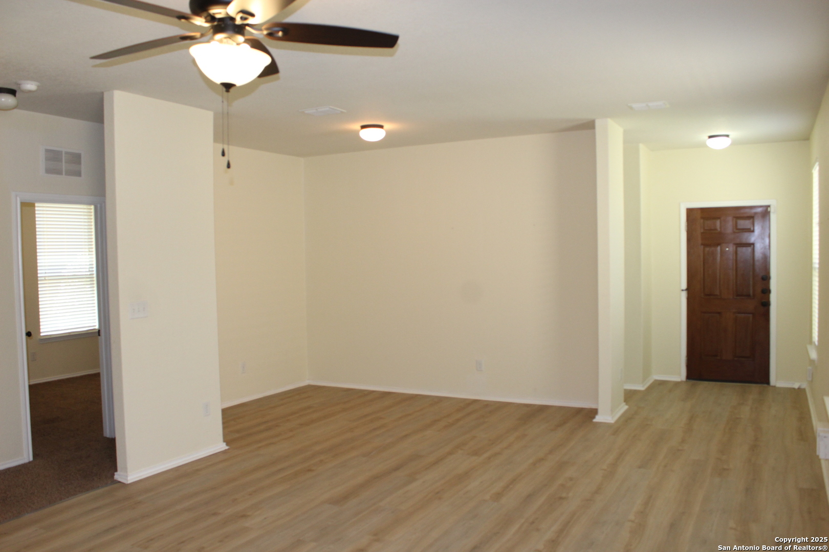 482 Walnut Crest Selma, TX 78154 - Photo 6 of 19 an empty room with wooden floor and fan