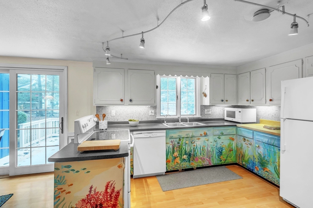 64 Heatherstone Road Amherst, MA 01002 - Photo 11 of 42 a kitchen with a stove a sink a refrigerator and window