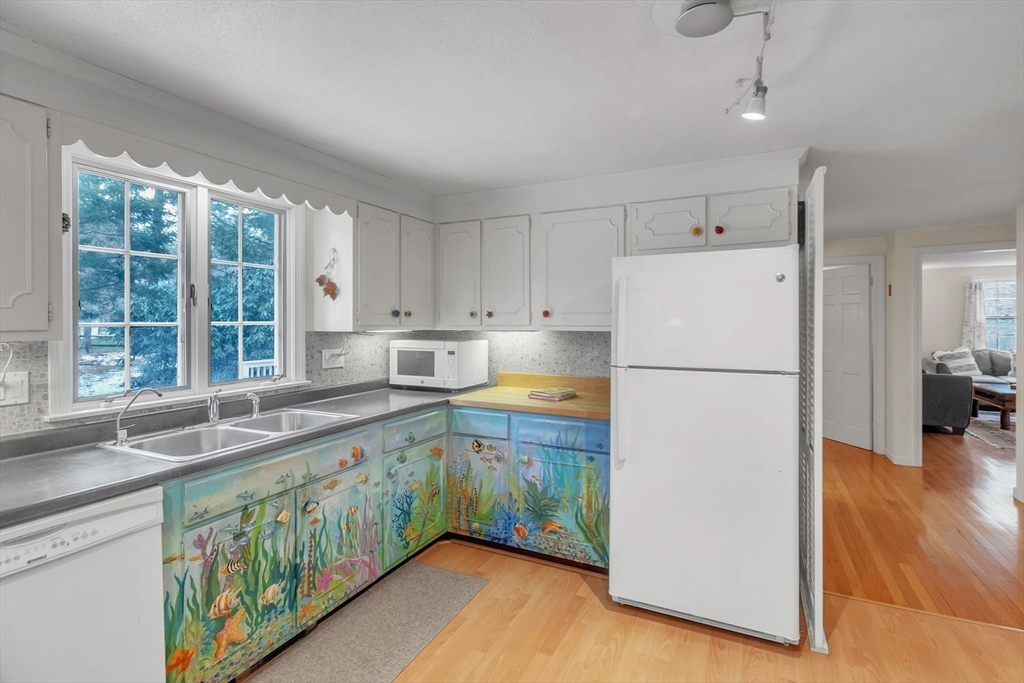 64 Heatherstone Road Amherst, MA 01002 - Photo 13 of 42 a kitchen with a refrigerator a sink and wooden cabinets