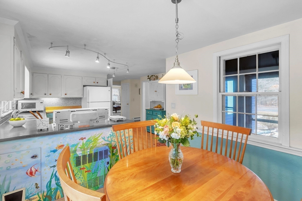 64 Heatherstone Road Amherst, MA 01002 - Photo 15 of 42 a kitchen with stainless steel appliances granite countertop a dining table and chairs