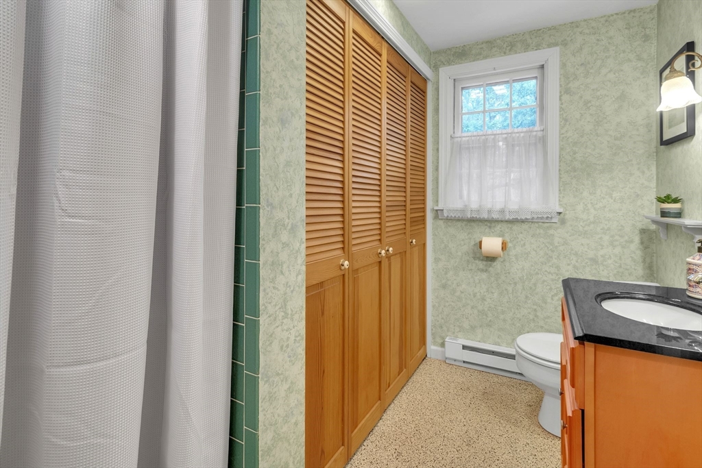 64 Heatherstone Road Amherst, MA 01002 - Photo 16 of 42 a bathroom with a granite countertop sink and a mirror