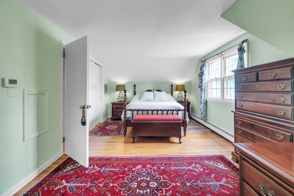 64 Heatherstone Road Amherst, MA 01002 - Photo 22 of 42 a spacious bedroom with a bed and a window