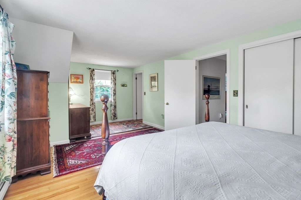 64 Heatherstone Road Amherst, MA 01002 - Photo 23 of 42 a bedroom with a bed and a refrigerator