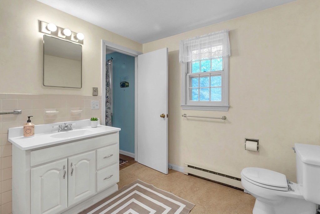 64 Heatherstone Road Amherst, MA 01002 - Photo 24 of 42 a spacious bathroom with a toilet sink and mirror