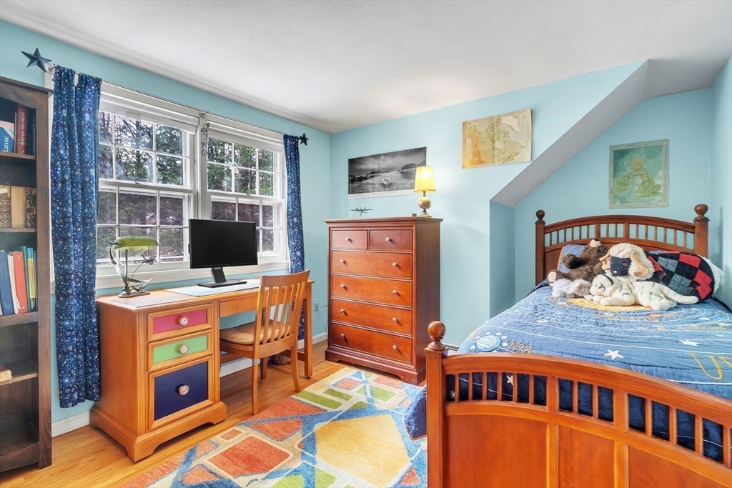 64 Heatherstone Road Amherst, MA 01002 - Photo 26 of 42 a bedroom with a bed and wooden floor