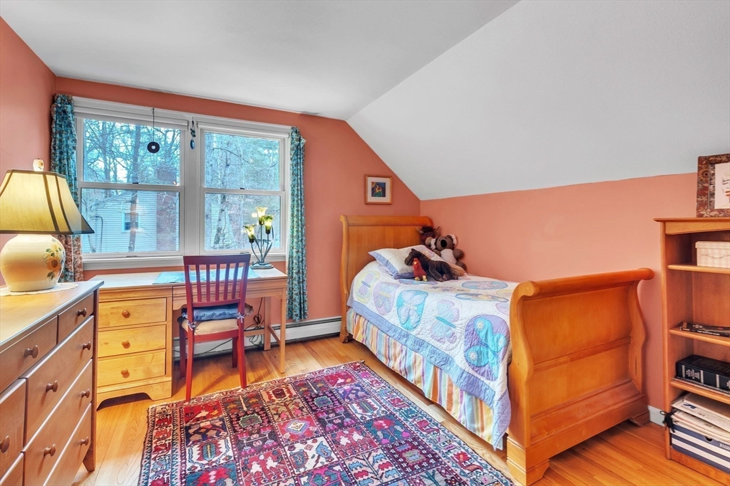 64 Heatherstone Road Amherst, MA 01002 - Photo 28 of 42 a bedroom with a bed and wooden floor