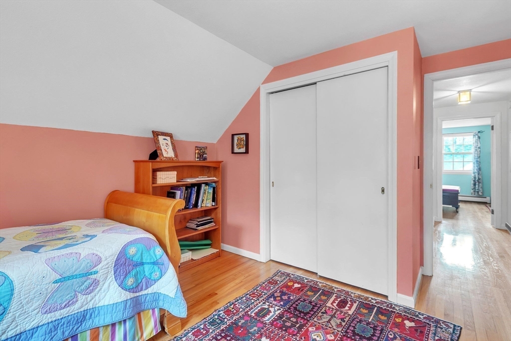 64 Heatherstone Road Amherst, MA 01002 - Photo 29 of 42 a bedroom with a bed and wooden floor