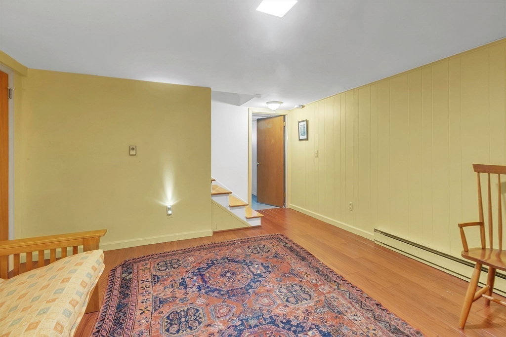 64 Heatherstone Road Amherst, MA 01002 - Photo 30 of 42 a view of an empty room with wooden floor and a window