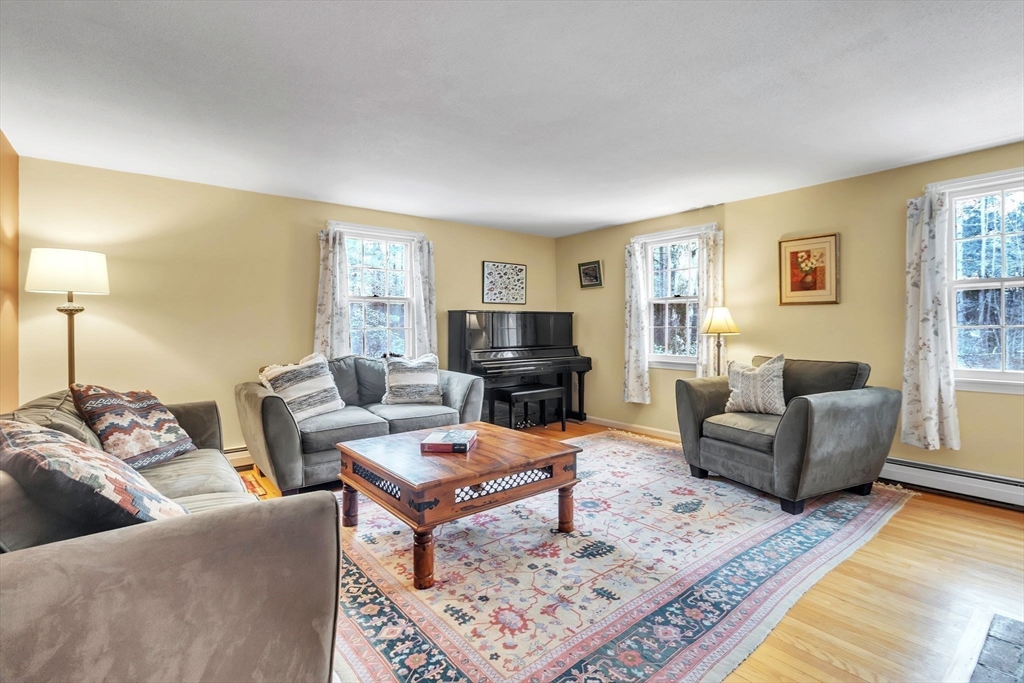 64 Heatherstone Road Amherst, MA 01002 - Photo 5 of 42 a living room with furniture and a flat screen tv