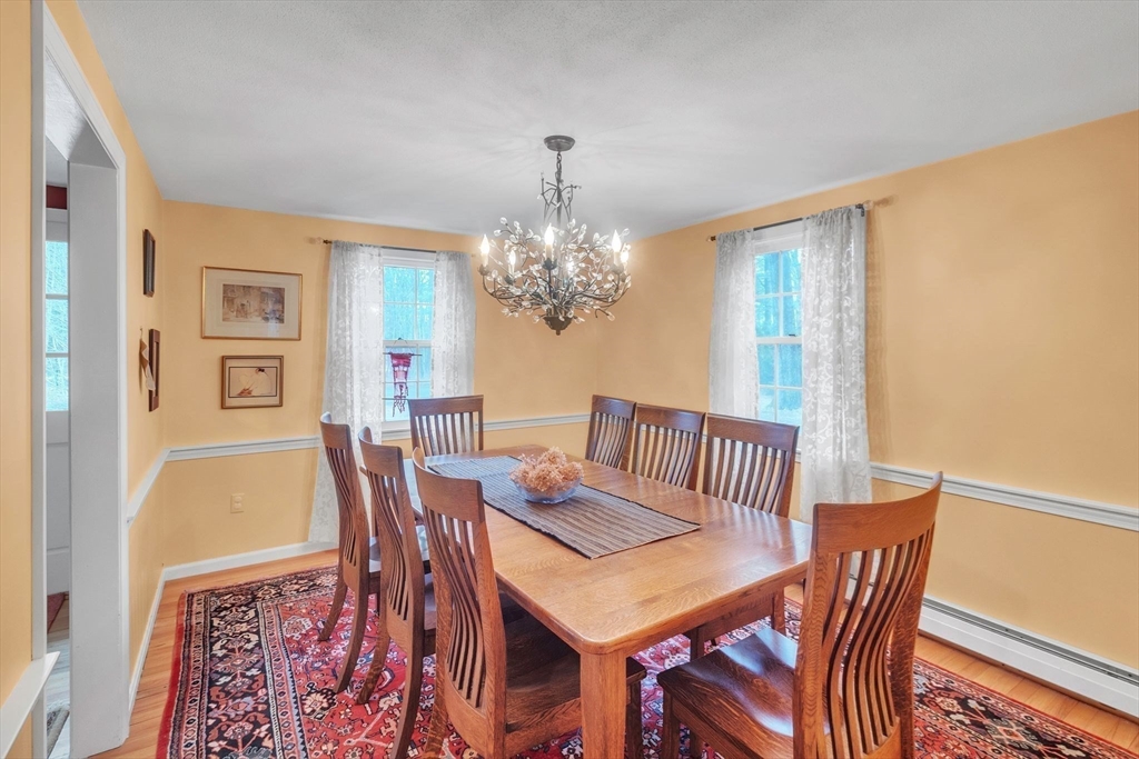 64 Heatherstone Road Amherst, MA 01002 - Photo 8 of 42 a view of a dining room with furniture and chandelier