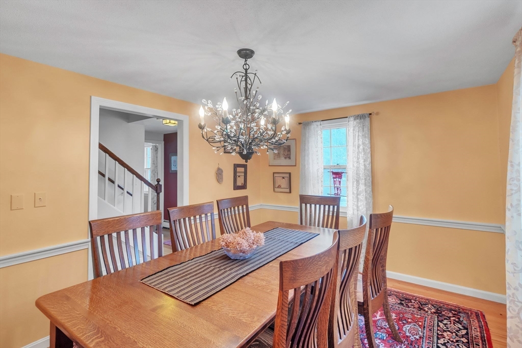 64 Heatherstone Road Amherst, MA 01002 - Photo 9 of 42 a view of a dining room with furniture and a chandelier