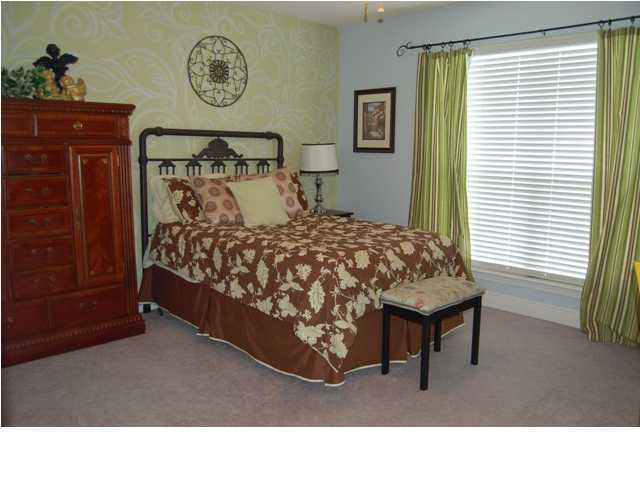 660 Territory Lane Crestview, FL 32536 - Photo 11 of 15 a bed room with a bed and a chair