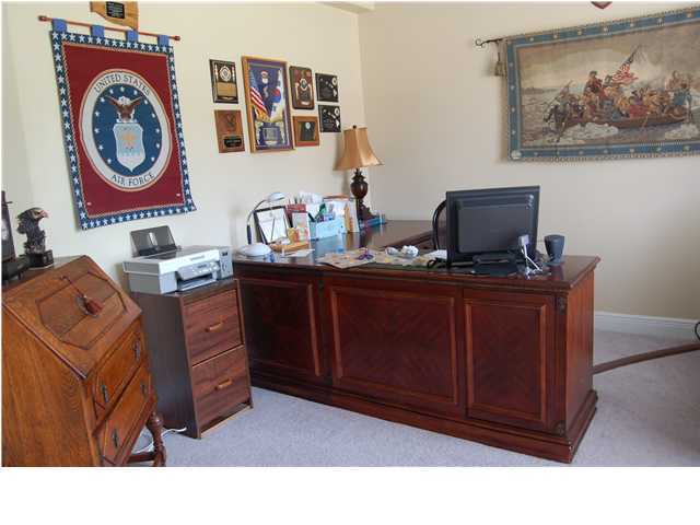 660 Territory Lane Crestview, FL 32536 - Photo 5 of 15 a living room with furniture and paintings on the wall