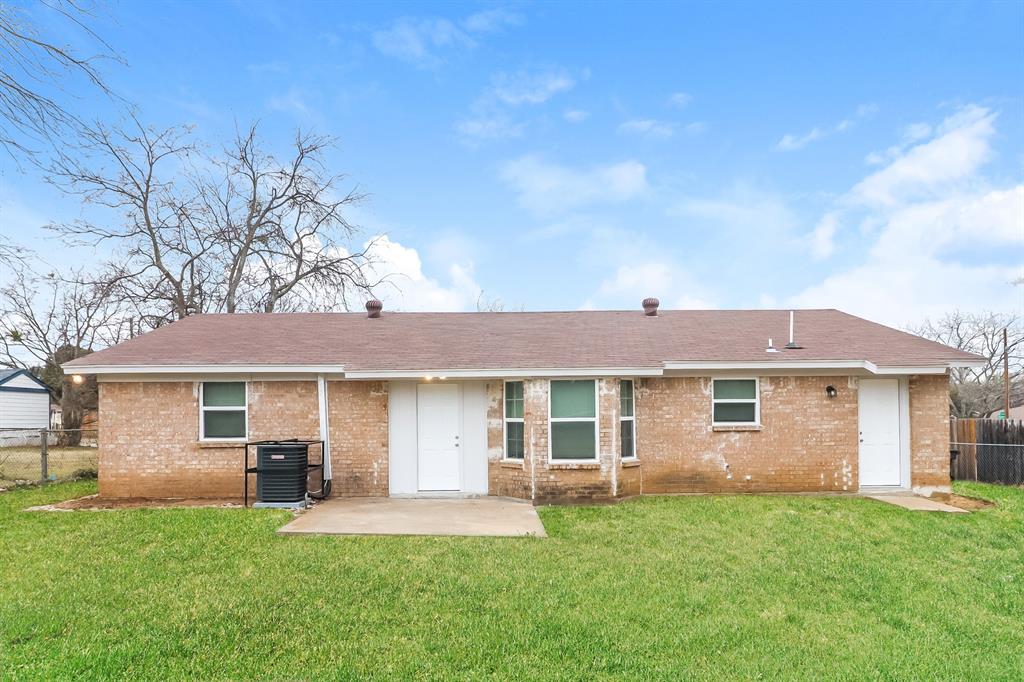 4117 Hatcher Street Fort Worth, TX 76119 - Photo 15 of 16 a front view of a house with a garden and yard