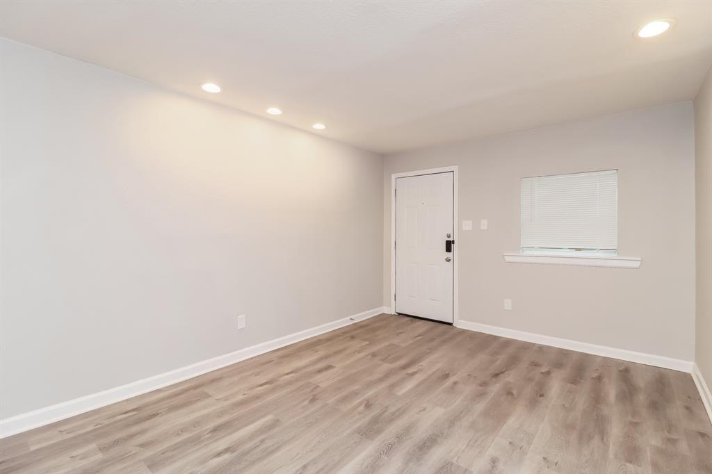 4117 Hatcher Street Fort Worth, TX 76119 - Photo 4 of 16 a view of an empty room with wooden floor