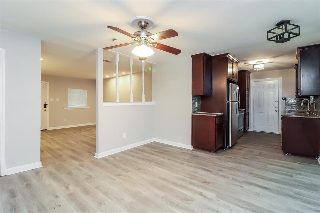 4117 Hatcher Street Fort Worth, TX 76119 - Photo 6 of 16 an empty room with wooden floor and way to kitchen