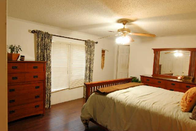 200 Old Railroad Road Prospect, TN 38477 - Photo 8 of 20 a bedroom with a bed and a chandelier