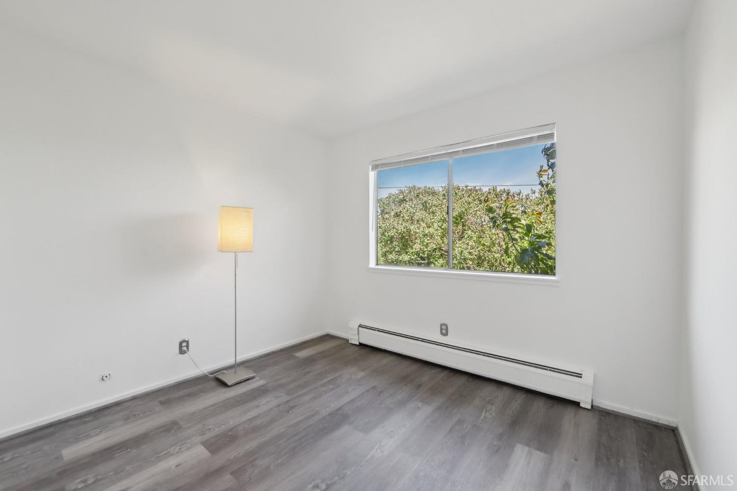 134 Albatross Court San Francisco, CA 94124 - Photo 11 of 40 an empty room with wooden floor and windows