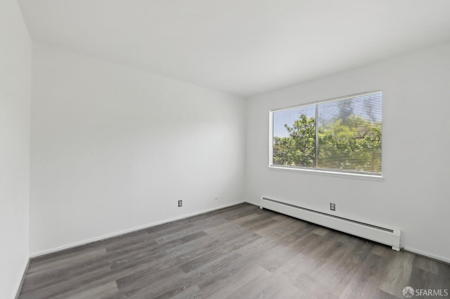134 Albatross Court San Francisco, CA 94124 - Photo 13 of 40 an empty room with wooden floor and window