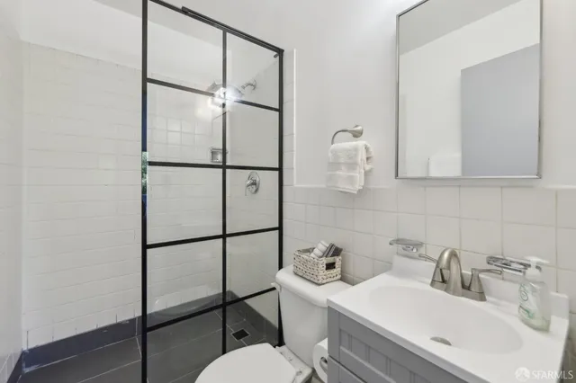 a bathroom with a sink toilet and shower