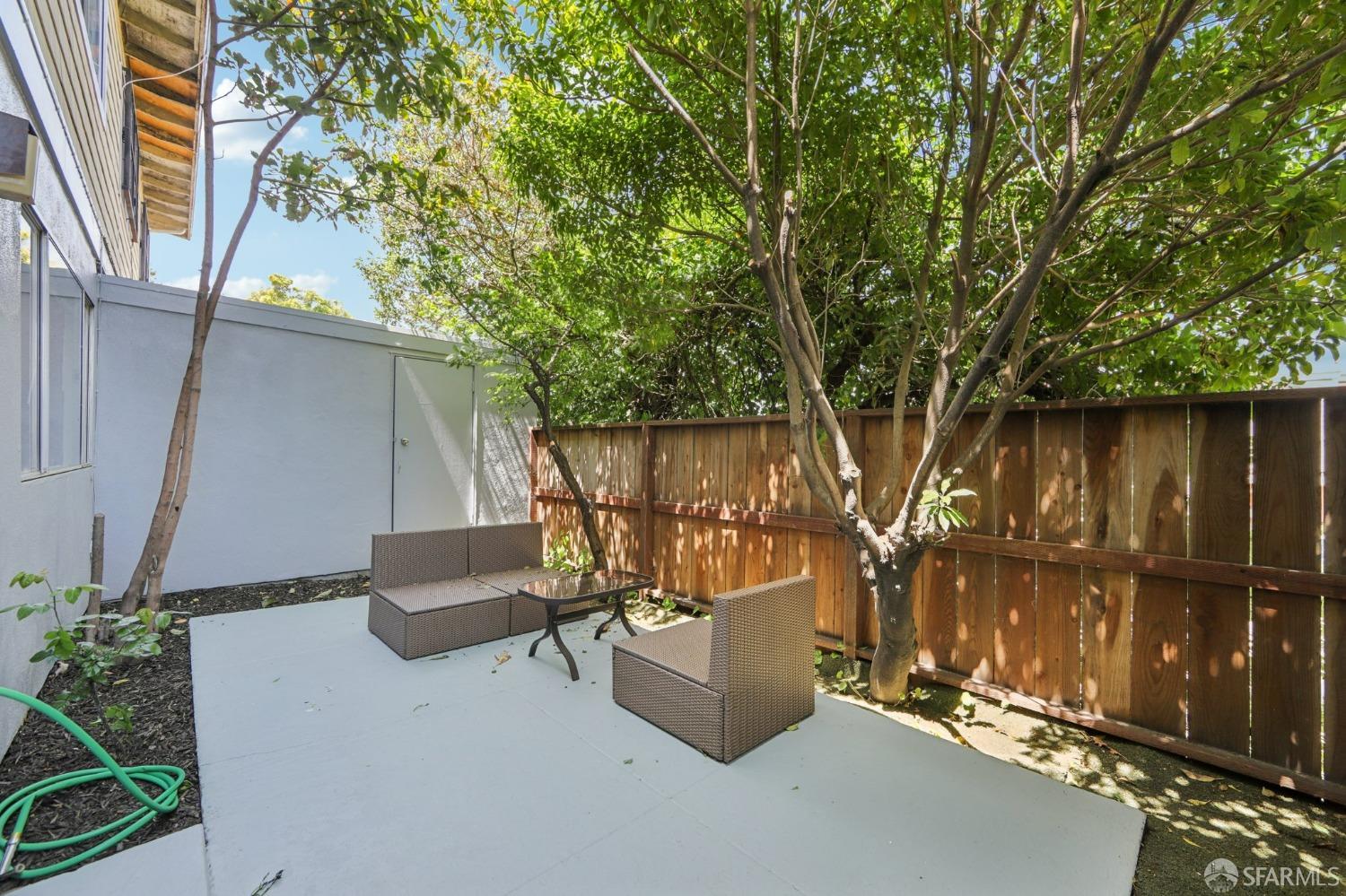 134 Albatross Court San Francisco, CA 94124 - Photo 18 of 40 a view of a patio with table and chairs with wooden fence and plants