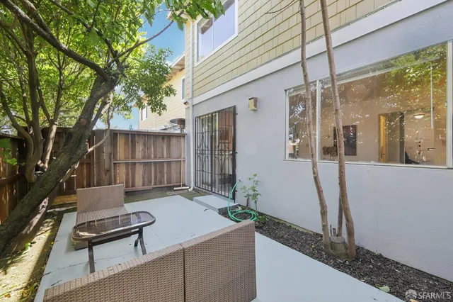a backyard of a house with table and chairs
