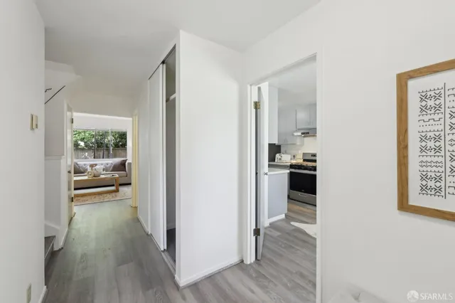 a view of a living room and dining room with wooden floor