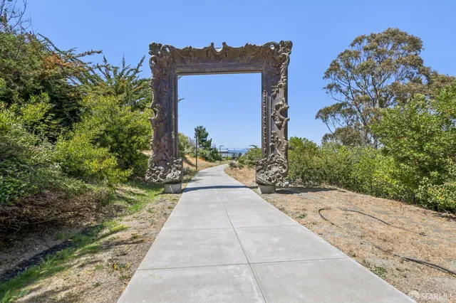 a view of a pathway with a small yard