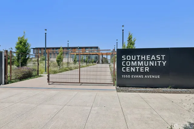 a view of a street with wooden fence