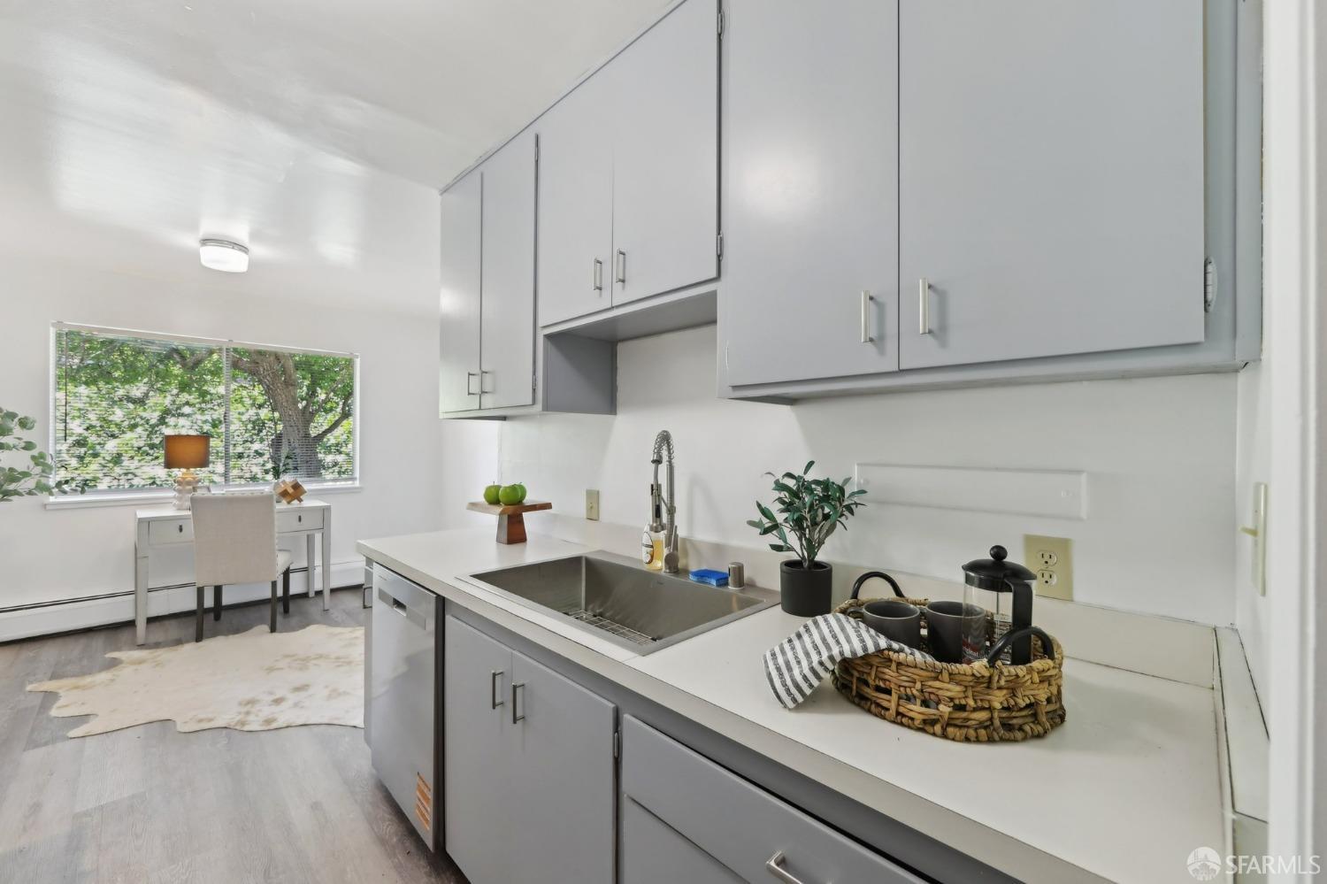 134 Albatross Court San Francisco, CA 94124 - Photo 7 of 40 a kitchen with white cabinets and window