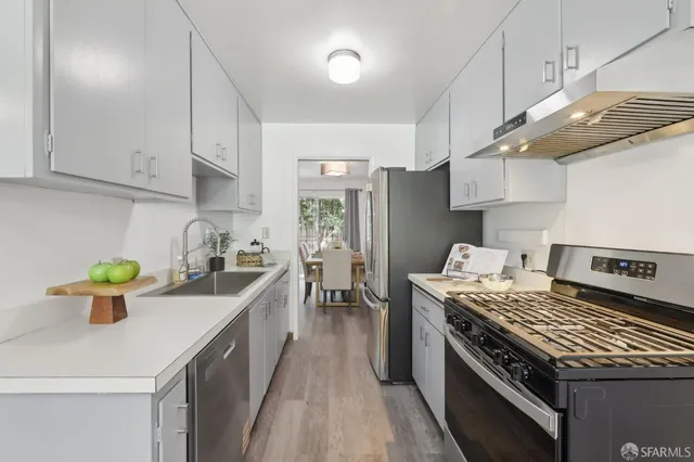 a kitchen with a stove a sink and a refrigerator