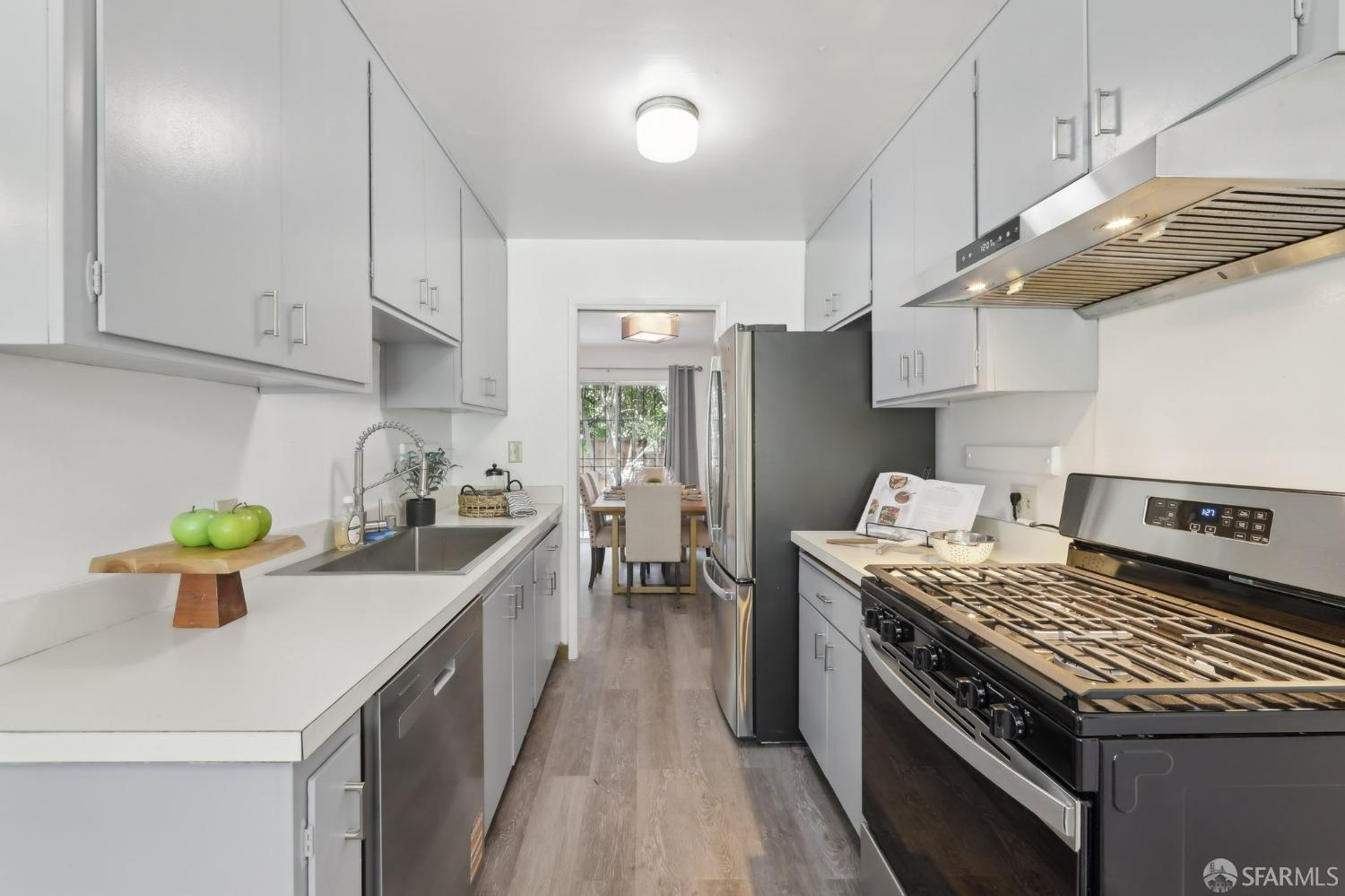 134 Albatross Court San Francisco, CA 94124 - Photo 8 of 40 a kitchen with a stove a sink and a refrigerator