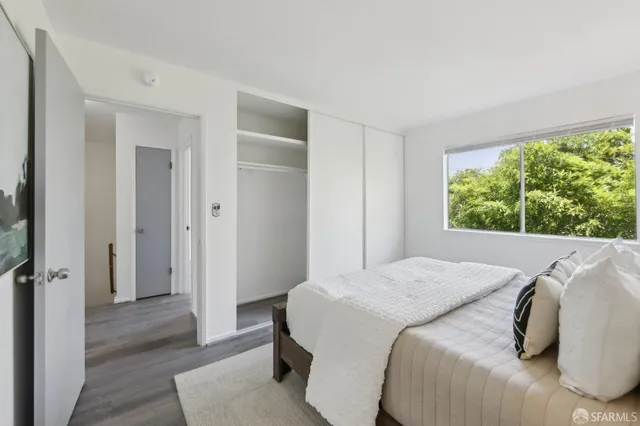 a bedroom with a bed and a window