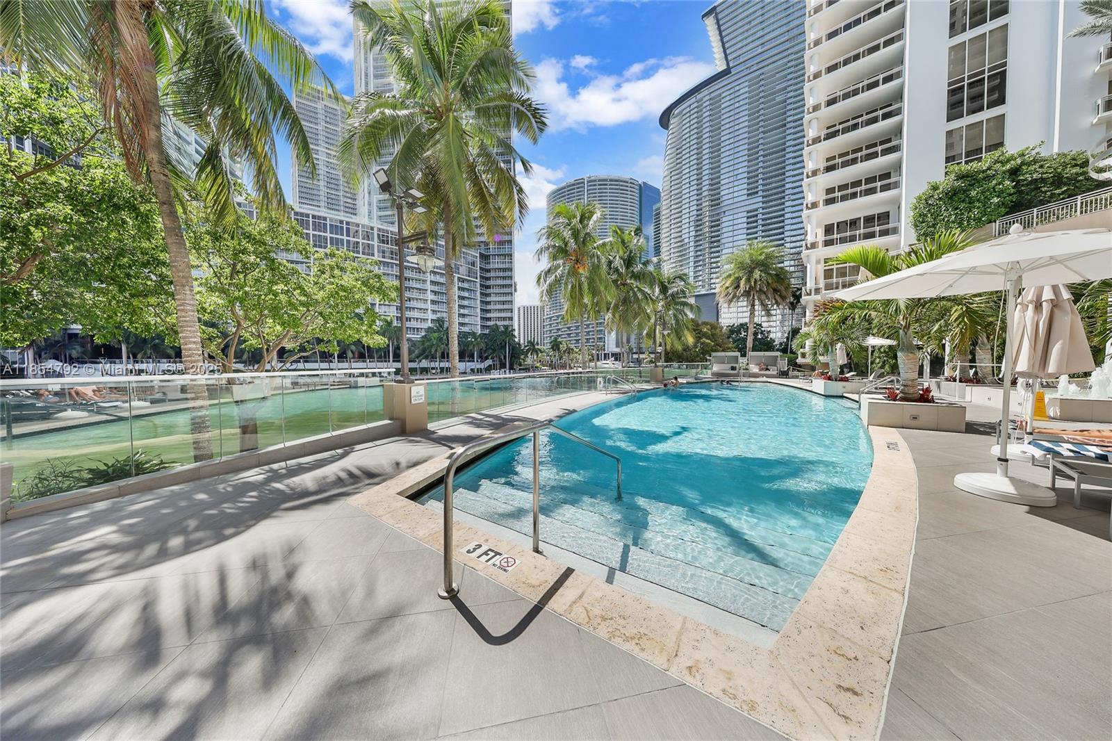 901 Brickell Key Boulevard, Unit 3002 Miami, FL 33131 - Photo 15 of 16 a view of a swimming pool with a patio