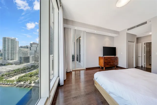 a bedroom with a bed and a television