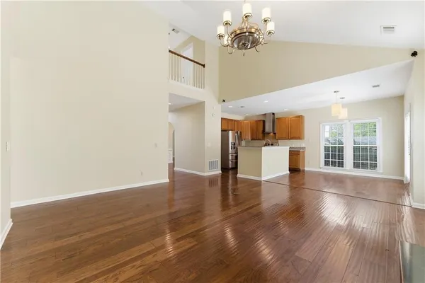 a view of empty room with wooden floor and fireplace