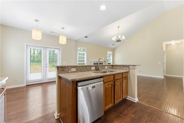 a kitchen with a sink and wooden floor