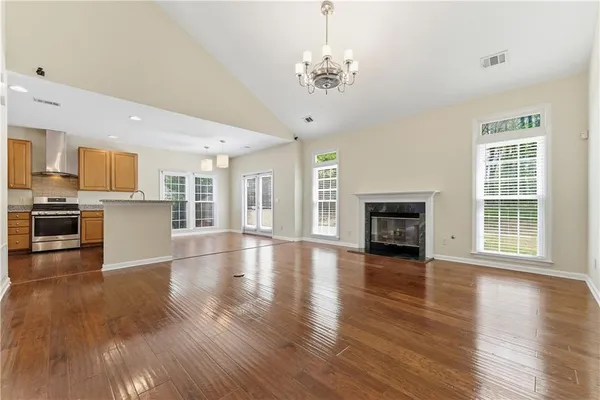 a view of empty room with wooden floor and fireplace