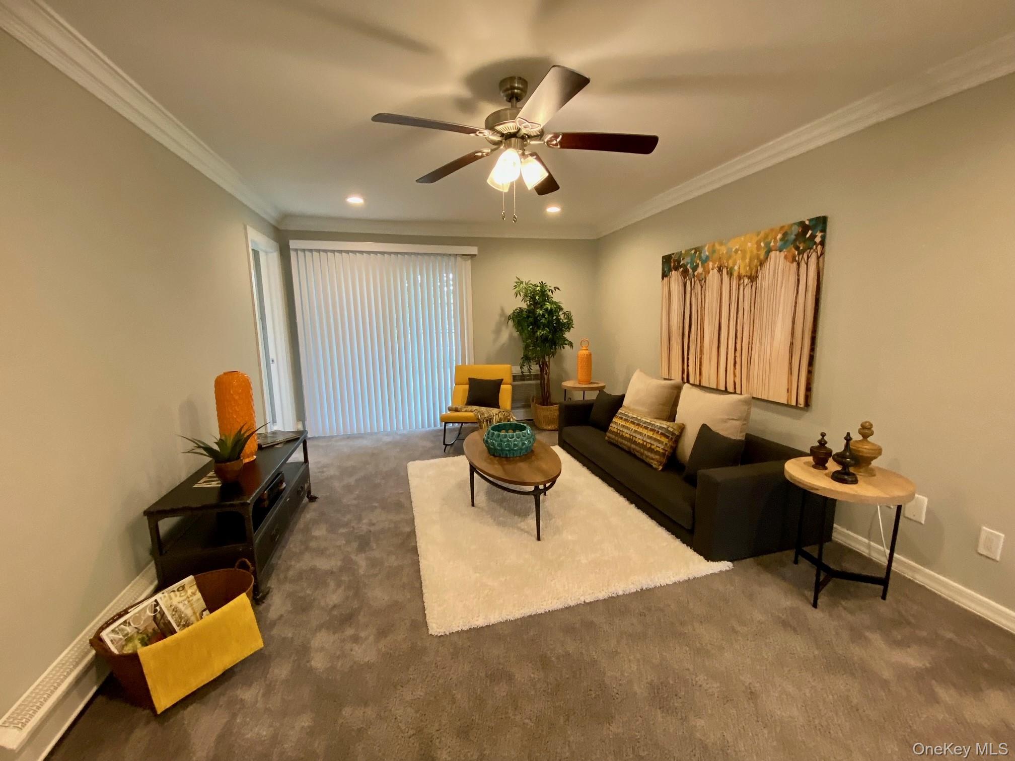 305 Terrace Road, Unit T07305 Bayport, NY 11705 - Photo 8 of 14 a living room with furniture and a chandelier