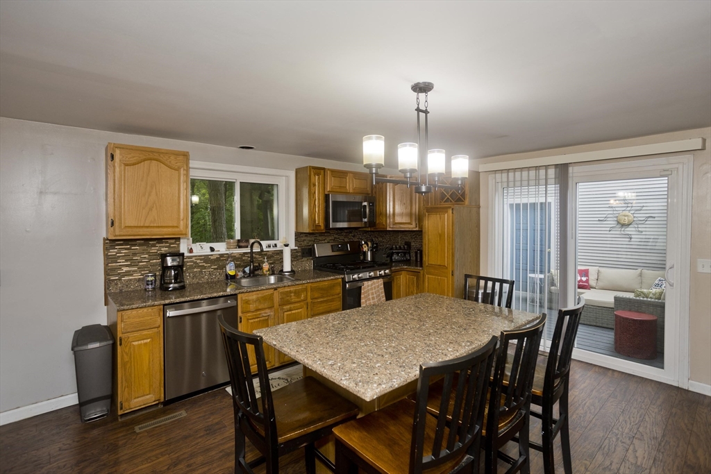 391 Plumtree Road Springfield, MA 01118 - Photo 11 of 42 a view of a dining room with furniture window and wooden floor