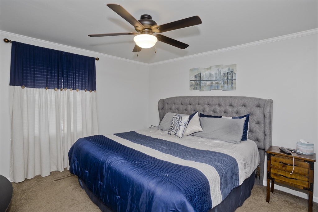391 Plumtree Road Springfield, MA 01118 - Photo 18 of 42 a bedroom with a bed and a chandelier