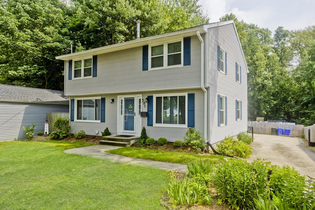 391 Plumtree Road Springfield, MA 01118 - Photo 2 of 42 a front view of a house with a yard and porch