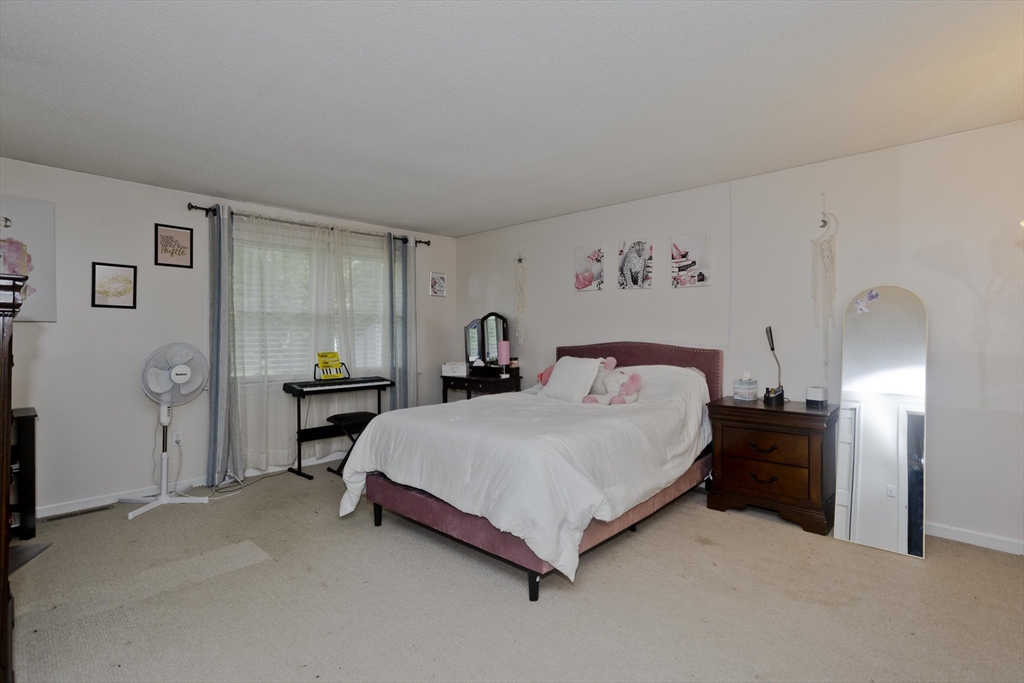 391 Plumtree Road Springfield, MA 01118 - Photo 24 of 42 a spacious bedroom with a bed and a cabinets