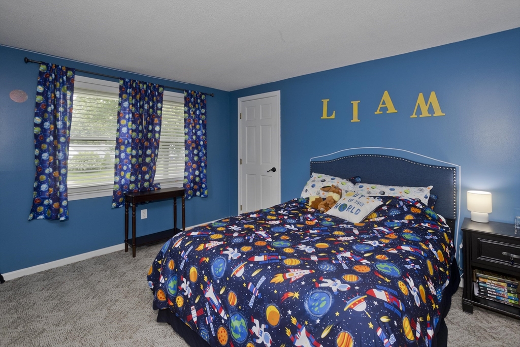 391 Plumtree Road Springfield, MA 01118 - Photo 27 of 42 a bedroom with a large bed and wooden floor