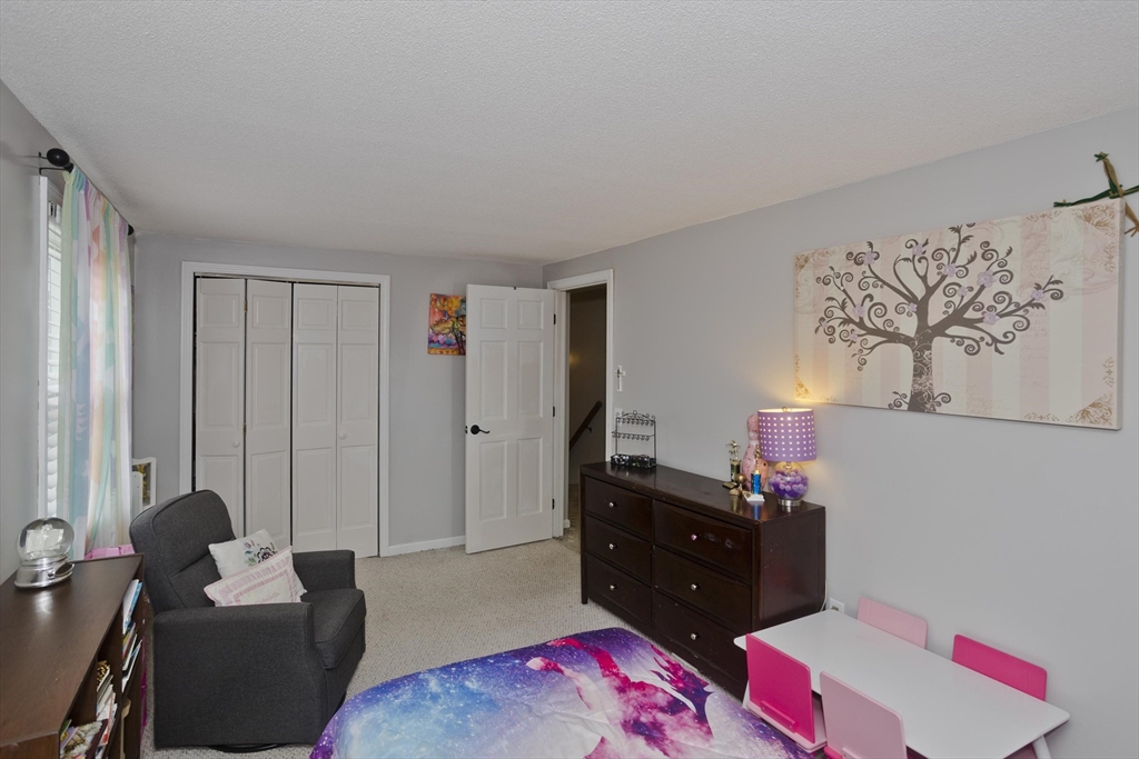 391 Plumtree Road Springfield, MA 01118 - Photo 29 of 42 a living room with furniture and a bed