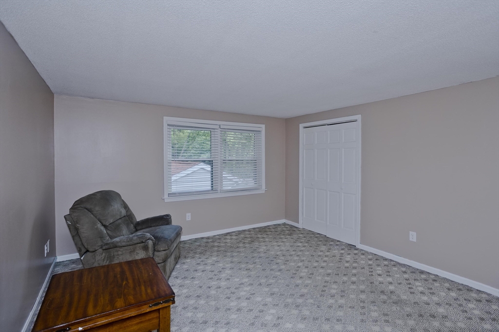 391 Plumtree Road Springfield, MA 01118 - Photo 31 of 42 a living room with furniture and a window