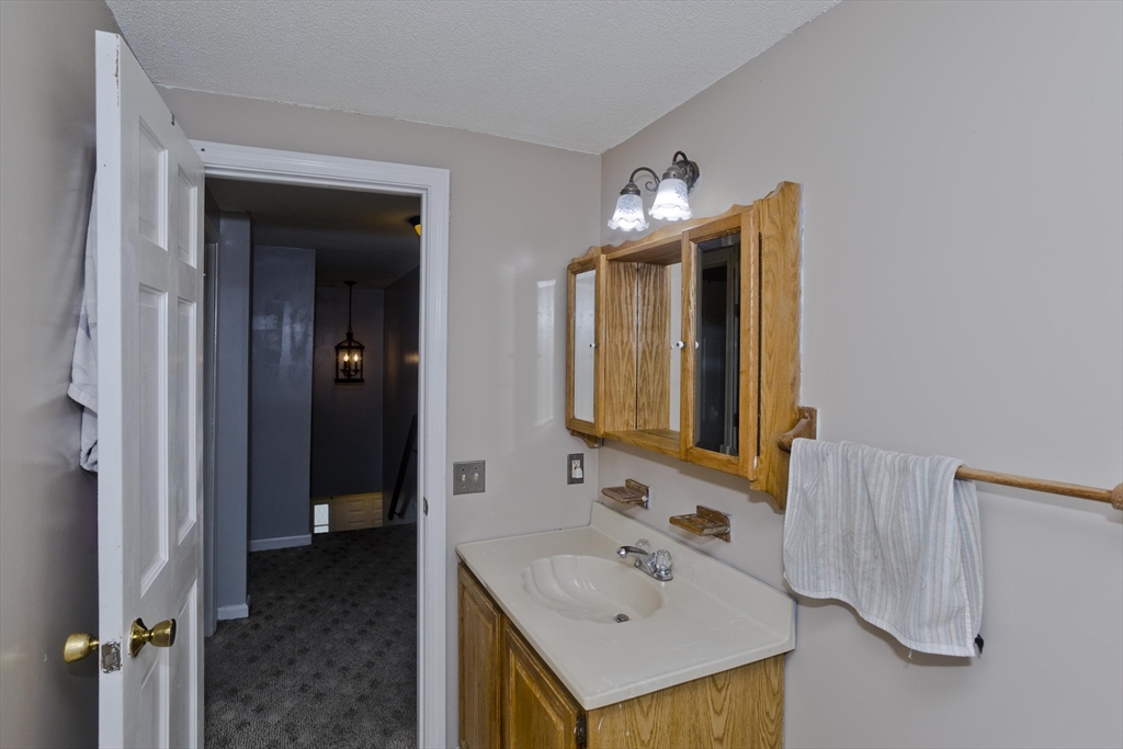 391 Plumtree Road Springfield, MA 01118 - Photo 33 of 42 a bathroom with a sink and a mirror