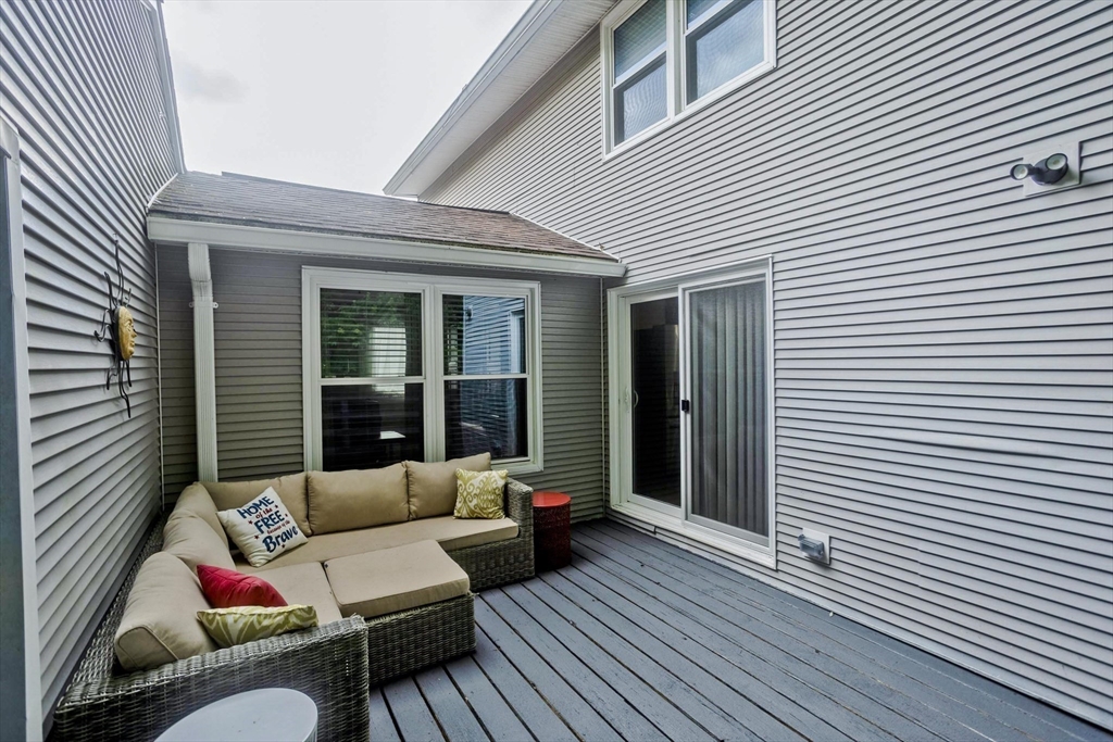 391 Plumtree Road Springfield, MA 01118 - Photo 38 of 42 a view of a patio with couches and a potted plant on a wooden floor