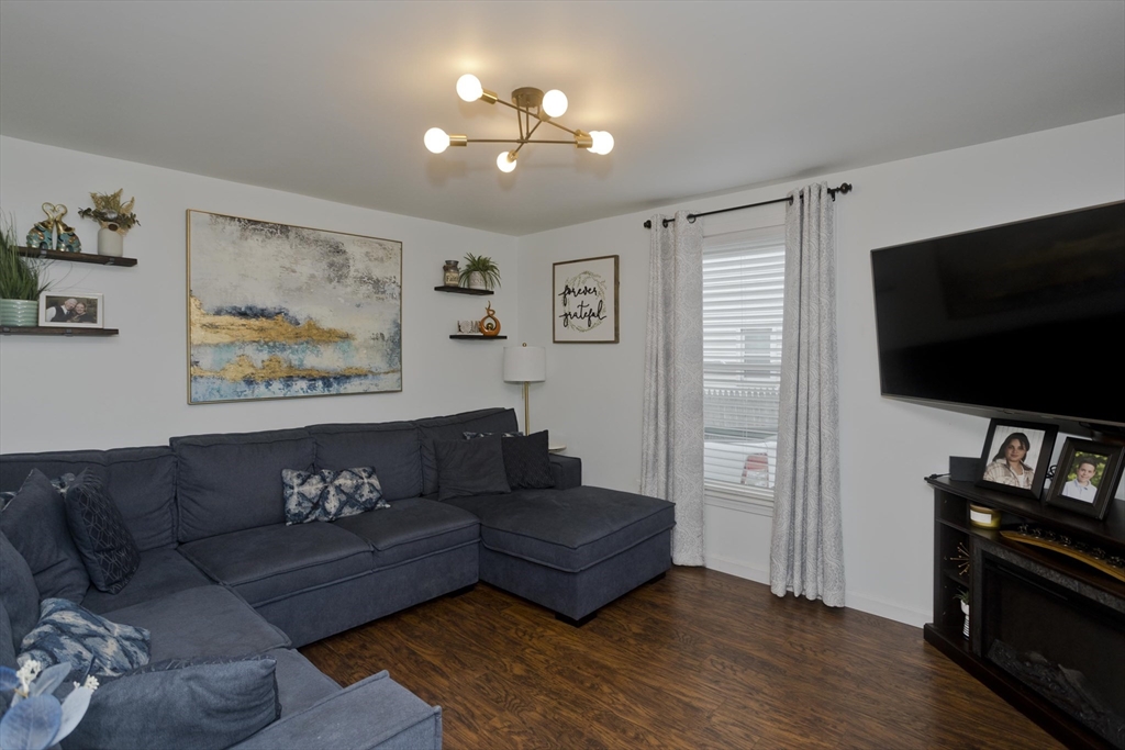 391 Plumtree Road Springfield, MA 01118 - Photo 6 of 42 a living room with furniture and a flat screen tv