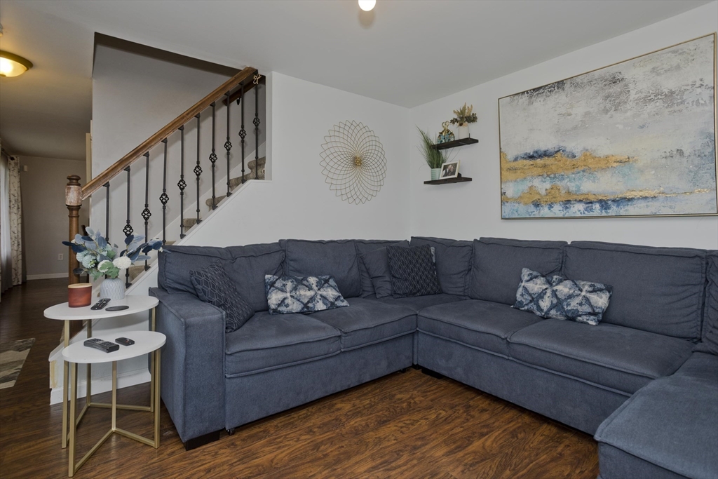 391 Plumtree Road Springfield, MA 01118 - Photo 7 of 42 a living room with furniture wooden floor and a painting on the wall